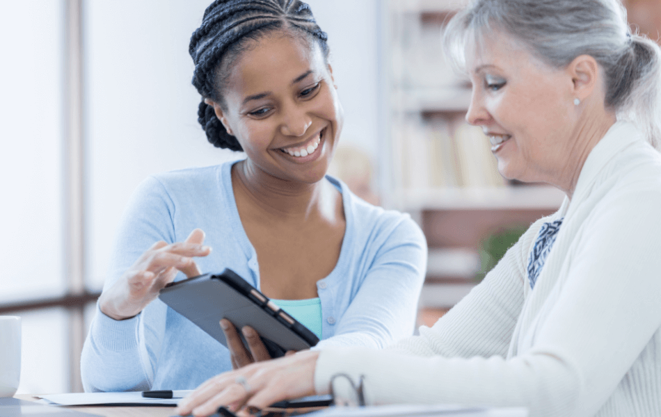 Two people looking at a tablet