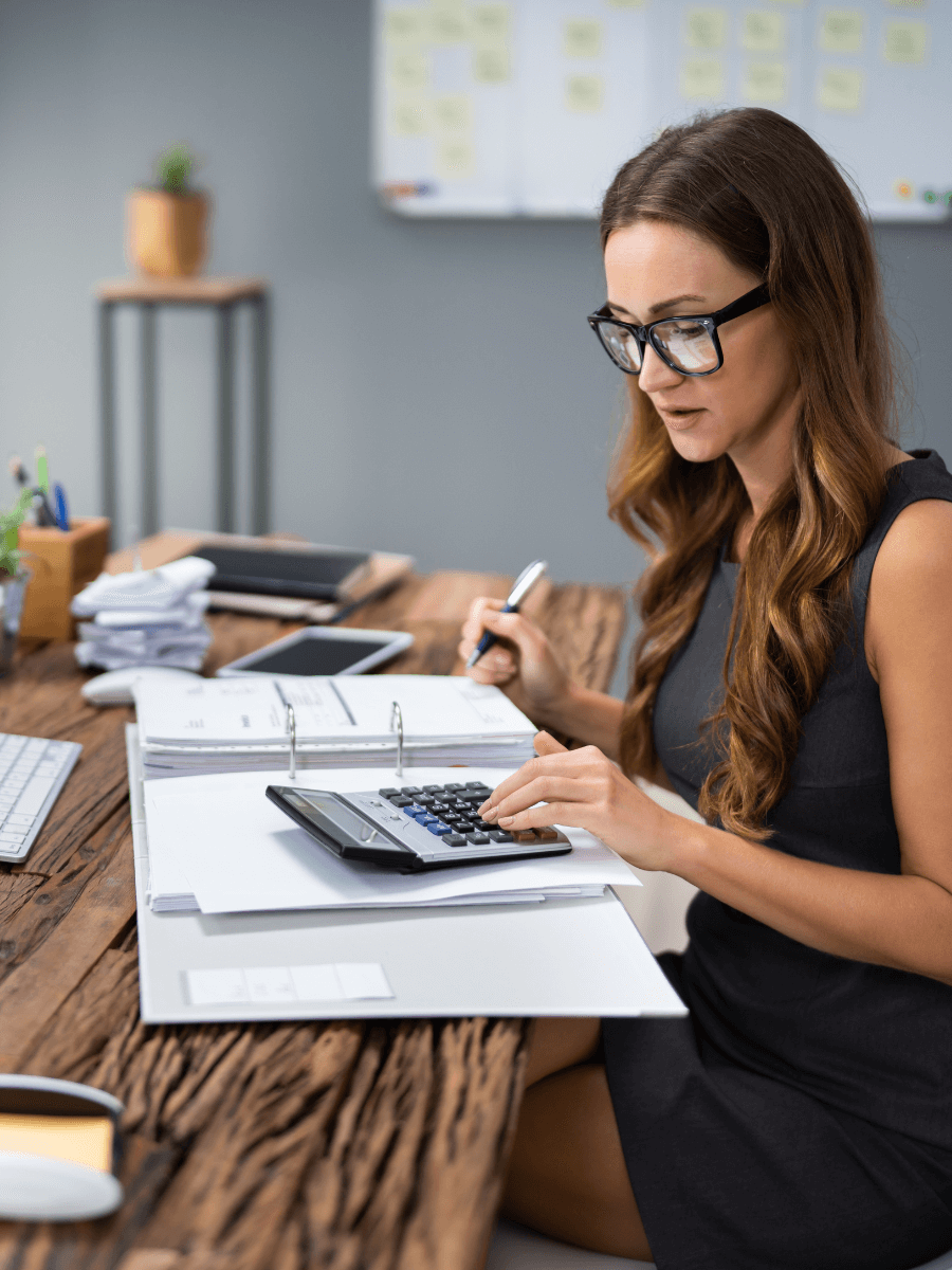 Person with a calculator and notebook